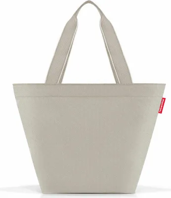 A plain studio shot of a beige tote bag.