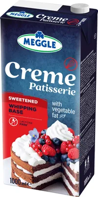 A carton of Meggle Creme Patisserie with a slice of cake decorated with whipped cream and berries.
