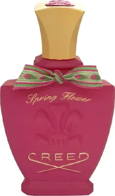 A studio shot of a pink Creed Spring Flower Eau de Parfum bottle.