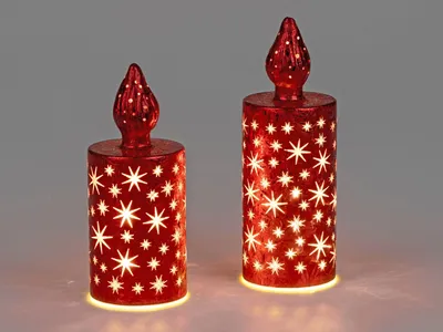 Two red decorative LED candles with star cutouts are shown against a light gray background.
