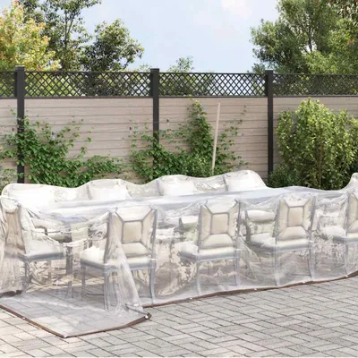 A transparent tarp covering a dining set on a patio.