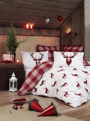 A cozy, rustic bedroom setting with Christmas-themed bedding and decorations.