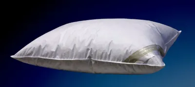 A white pillow against a dark blue to black gradient background.