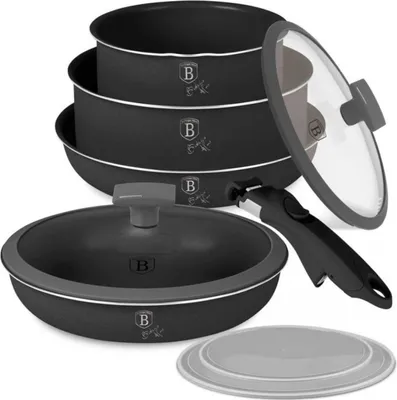 A set of cookware, including pots and a pan, stacked and arranged with a lid and a handle.