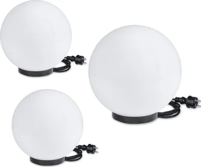 Three white globe lights with black bases and cords, arranged on a white background.