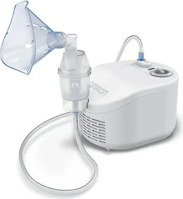 A white Omron C101 Essential nebulizer with its attached mask and tubing is shown against a white background.