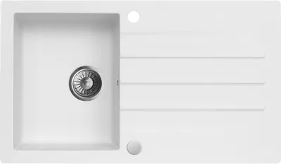 A top-down view of a white kitchen sink with a drain and a ribbed draining board.