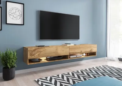 A modern living room with a wall-mounted TV and entertainment unit.
