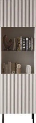 A tall, narrow display cabinet with fluted detailing on the doors and sides, standing on black metal legs. The shelves inside hold books and decorative items.