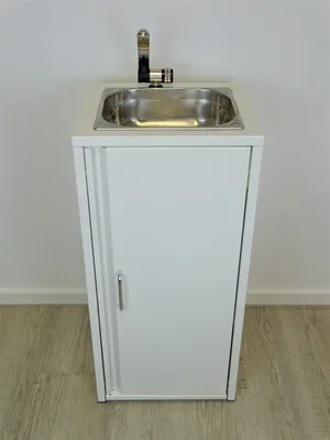 A white cabinet with a stainless steel sink and faucet.