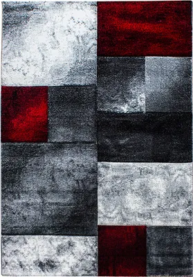 A close-up, top-down view of a rectangular rug with a modern, abstract geometric design.