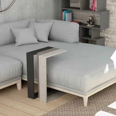 A modern living room scene with a sectional sofa and a C-shaped side table.