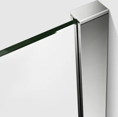 A close-up view of a shower enclosure corner, showing the glass panel and a silver-colored metal frame.