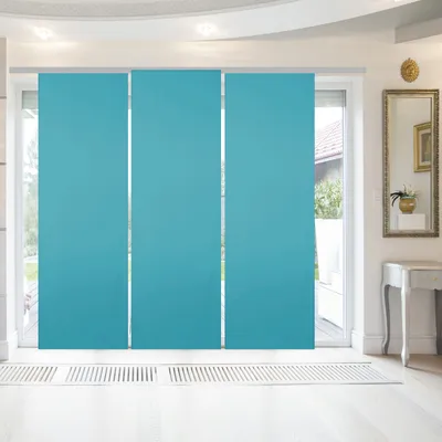 A room interior with sliding panel curtains covering a large window.