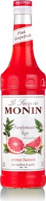 A bottle of Monin Pink Grapefruit syrup.