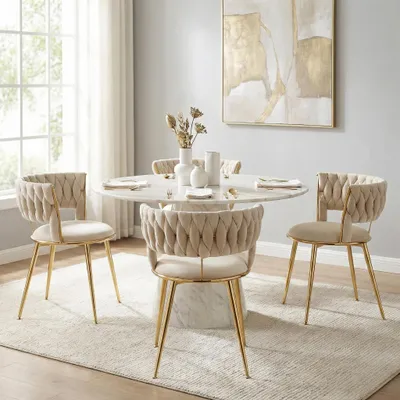 A dining set with four chairs and a round table in a well-lit room.