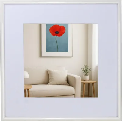A framed picture of a red poppy hangs on a wall above a sofa in a living room.