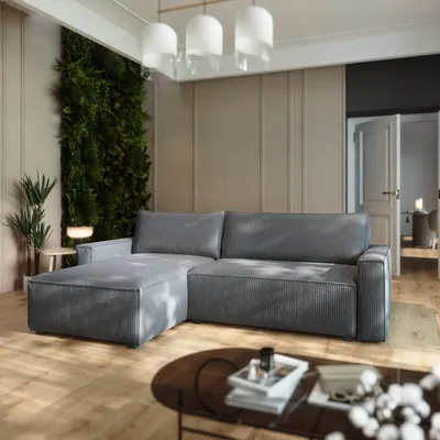 A modern living room with a gray sectional sofa, a vertical garden wall, and a coffee table.
