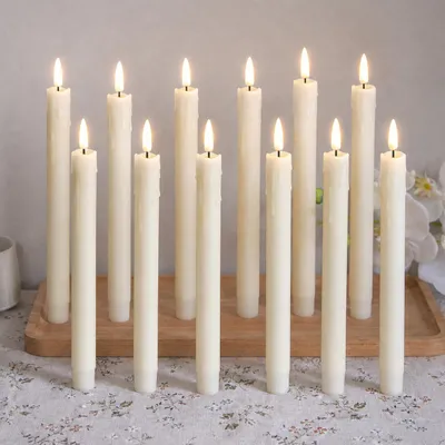 Immagine prodotto di 12 candele a LED a forma di bastoncino, luce bianco caldo, 19 cm, senza fiamma, alimentate a batteria, ideali per decorazioni natalizie, matrimoni, feste ed eventi, colore avorio