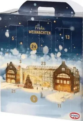 A Dr. Oetker Advent calendar with a winter scene of buildings and a Christmas tree.
