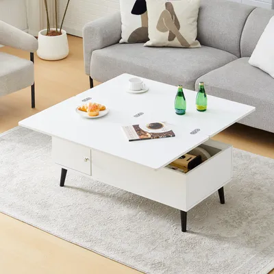 A white lift-top coffee table with storage is shown in a living room setting, with a sofa and armchair in the background.
