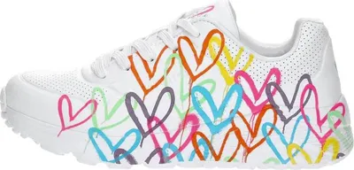 A side view of a white sneaker with a colorful heart print.