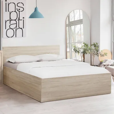 A bedroom scene with a bed, pillows, and a headboard.
