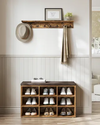 An entryway with a shoe bench, shelf, hat, and scarf.