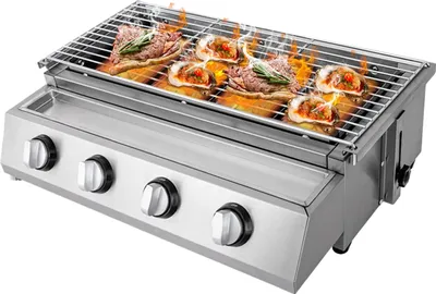 A stainless steel propane BBQ grill with food cooking on the grate.