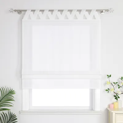 A white Roman blind with a decorative header is shown hanging on a window.
