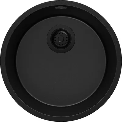 A top-down view of a black round kitchen sink with a drain.