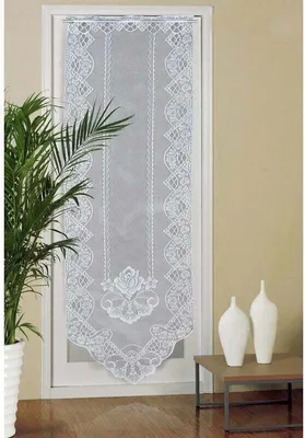 A white lace door curtain hanging on a door frame, with a potted plant to the left and decorative vases on a table to the right.