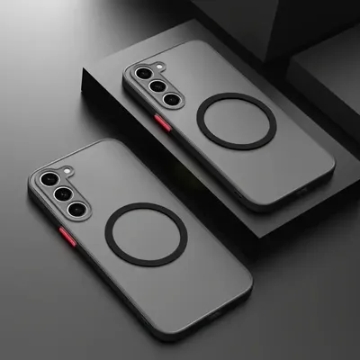 Two phone cases with magnetic rings are displayed on a dark, angular surface.