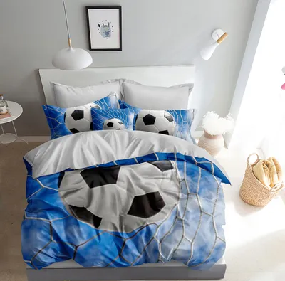 A bedroom scene with a bed made up with soccer-themed bedding.