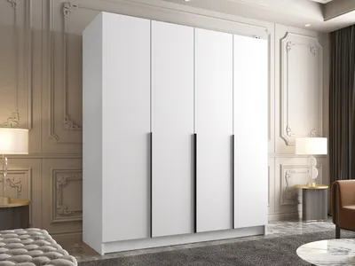 A modern white wardrobe with black handles in a well-decorated room.