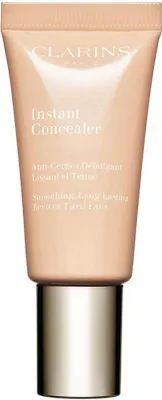 A tube of Clarins Instant Concealer with a gold cap.