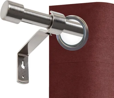 A close-up view of a metal curtain rod and bracket against a dark red curtain.