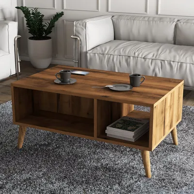 A modern living room scene with a coffee table in the foreground and a sofa in the background.