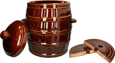 A brown ceramic fermentation crock with its lid and two weights, shown on a white background.