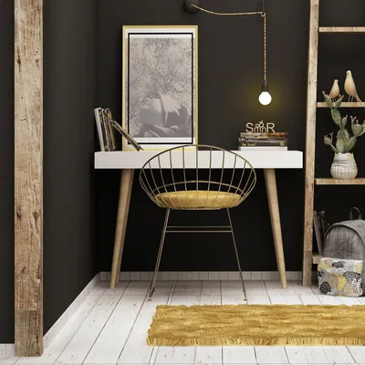A modern home office setup with a white desk, gold chair, and decorative items.