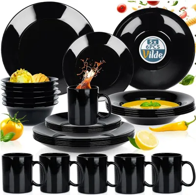 A collection of black dinnerware and mugs is displayed on a white background, with some food items and decorative elements.