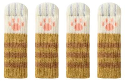Four knitted chair leg covers with a cat paw design.