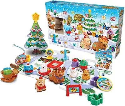 A VTech TUT TUT Tiere Advent Calendar with various animal figures and Christmas-themed accessories laid out on a play mat.