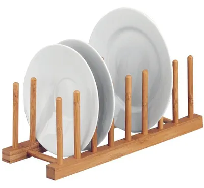 A wooden dish rack holding several white plates.