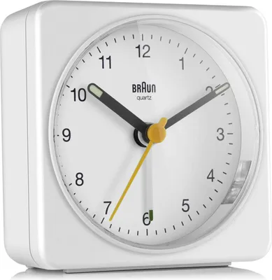 A white Braun alarm clock is shown against a white background.