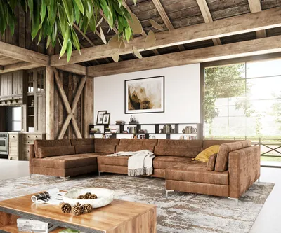 A spacious living room with a large sectional sofa, wooden beams, and a large window overlooking greenery.