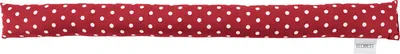 A red and white polka dot draft stopper lies horizontally on a white background.