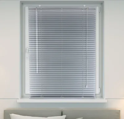 A close-up view of a window with silver blinds.