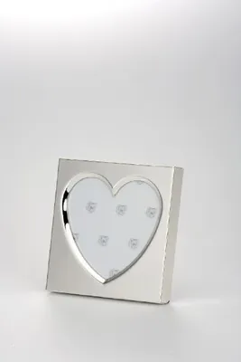 A silver heart-shaped photo frame is displayed on a white surface against a white background.
