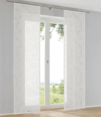 A window with sheer curtains and a view of greenery outside.